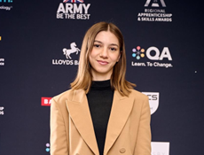 Petronela Bodnari standing in front of an apprenticeship awards backdrop after receiving recognition for her achievements.<br />

